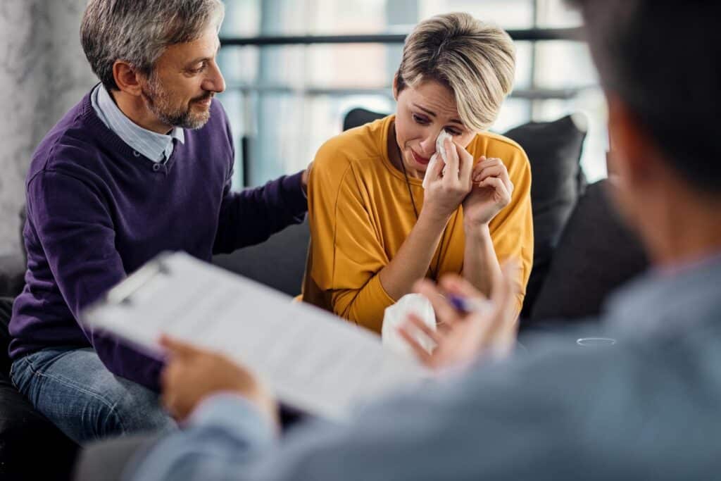 sad woman crying while being with her husband therapy with counselor Fair Asset Division in Divorce: Navigating Marital Property & Protecting Your Future