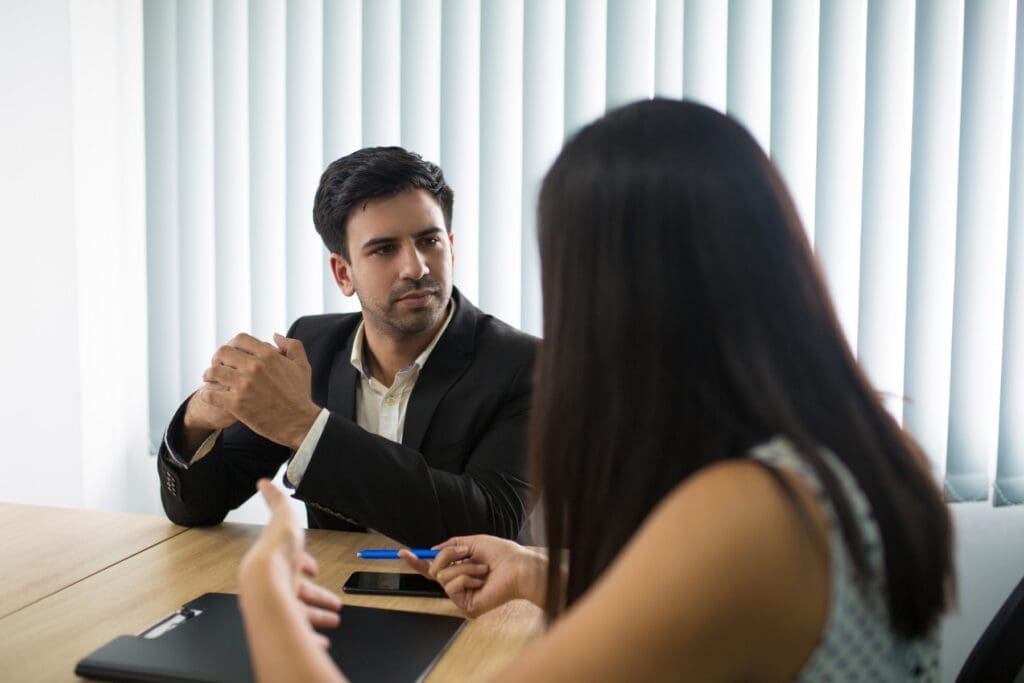 serious executive listening female partner employee Fair Asset Division in Divorce: Navigating Marital Property & Protecting Your Future